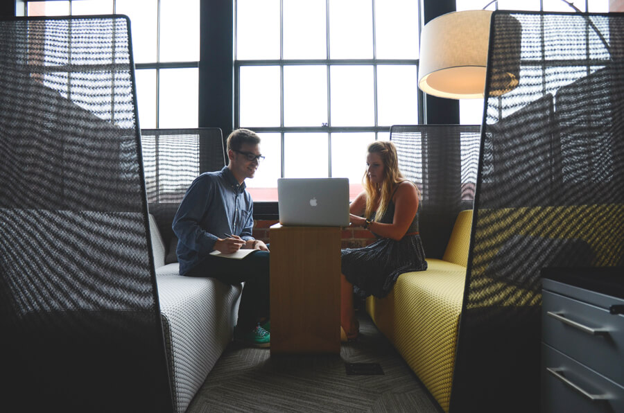 Two people working together on a laptop.