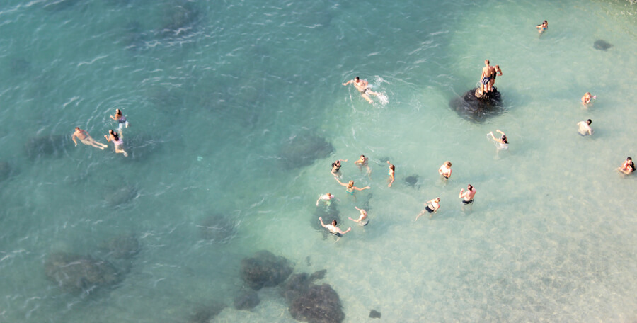 People enjoying a beach on the ocean.