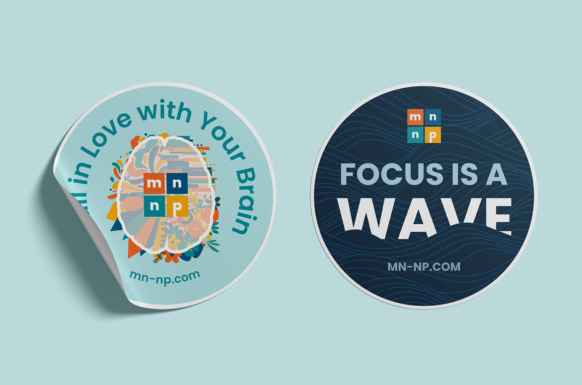 Two promotional stickers for Minnesota Neuropsychology: one reads 'Fall in Love with Your Brain' with a colorful brain illustration, the other reads 'Focus is a Wave' on a blue background.